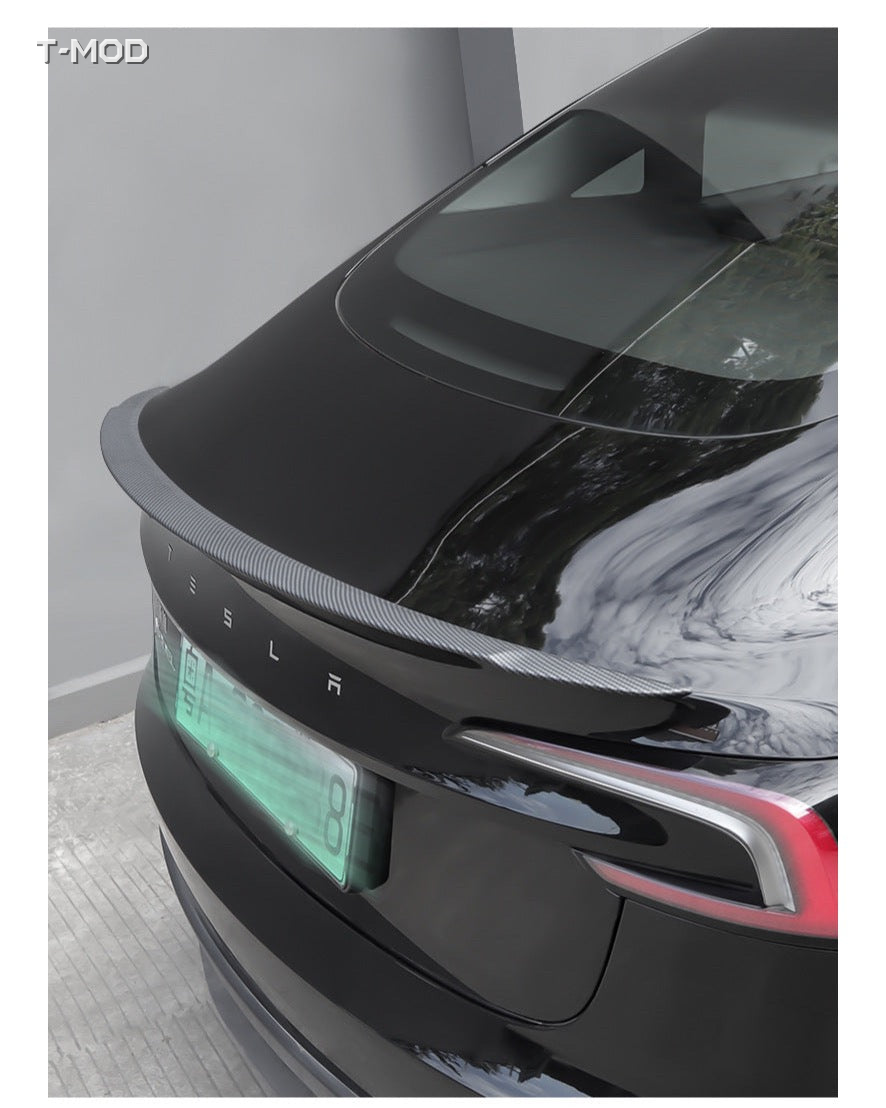 Carbon-fiber-textured performance-style spoiler installed on a Tesla rear trunk
