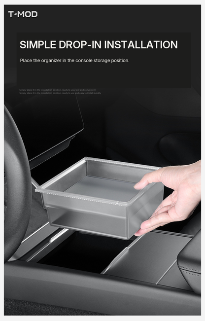 Hand placing the lower tray into the center-console storage position to demonstrate drop-in installation for Tesla Model 3 (2024+) — Highland, Tesla Model Y (2025+) — Juniper — AWD, and Tesla Model YL (2025+) — 6-Seater.