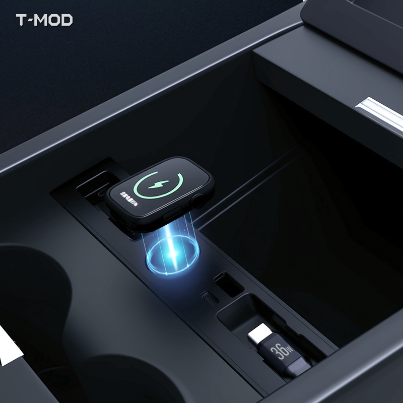 Hidden center-console charging hub with wireless watch-charging position; watch shown for demonstration