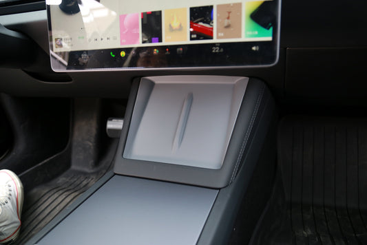 Gray wireless charging pad installed in Tesla Model 3 Highland center console