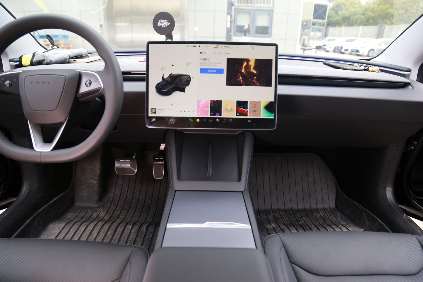 Gray wireless charging pad shown in Tesla Model 3 Highland interior